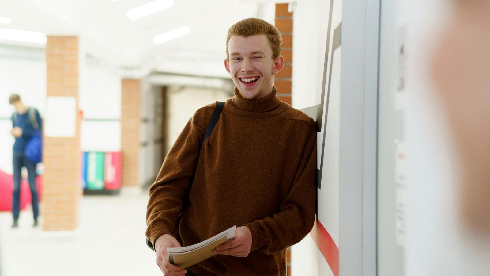 high school student laughing in hallway