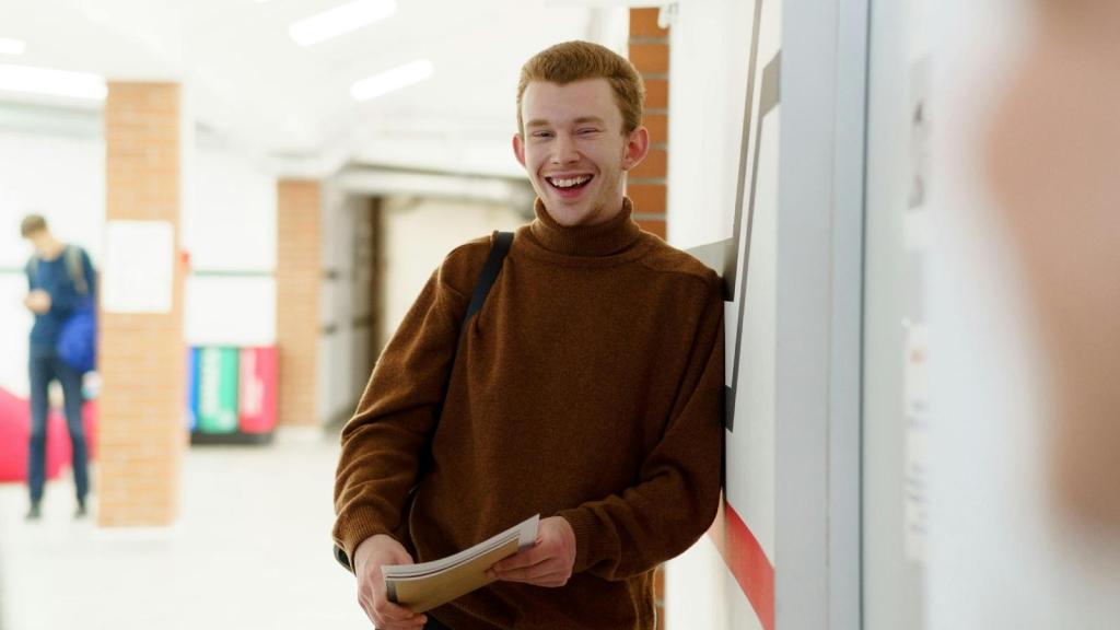 high school student laughing in hallway