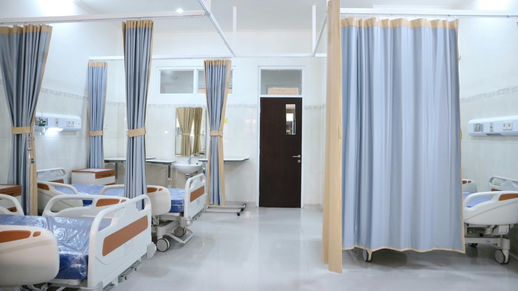 hospital room with beds, curtains, etc.
