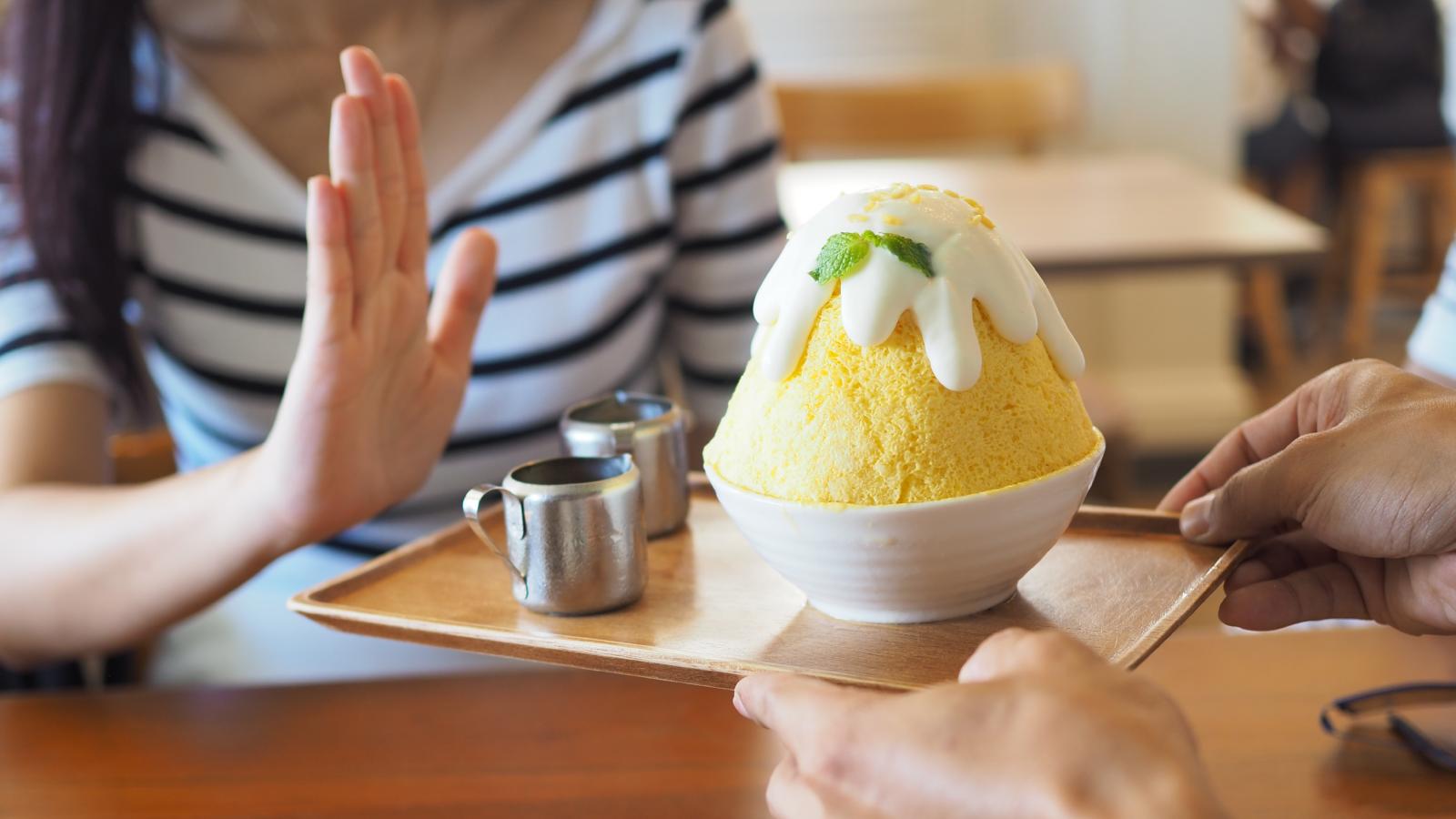 woman refusing ice cream