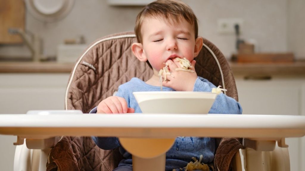 kid shoving food into his mouth