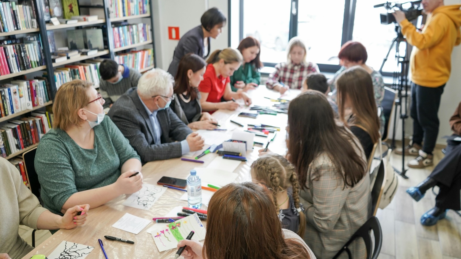 people at a long table at a library event