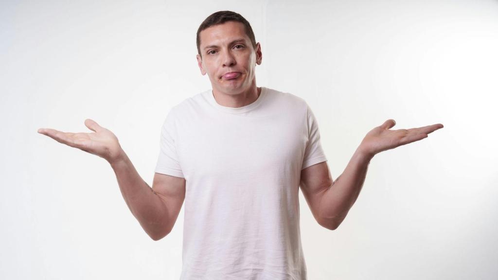 man in white shirt shrugging