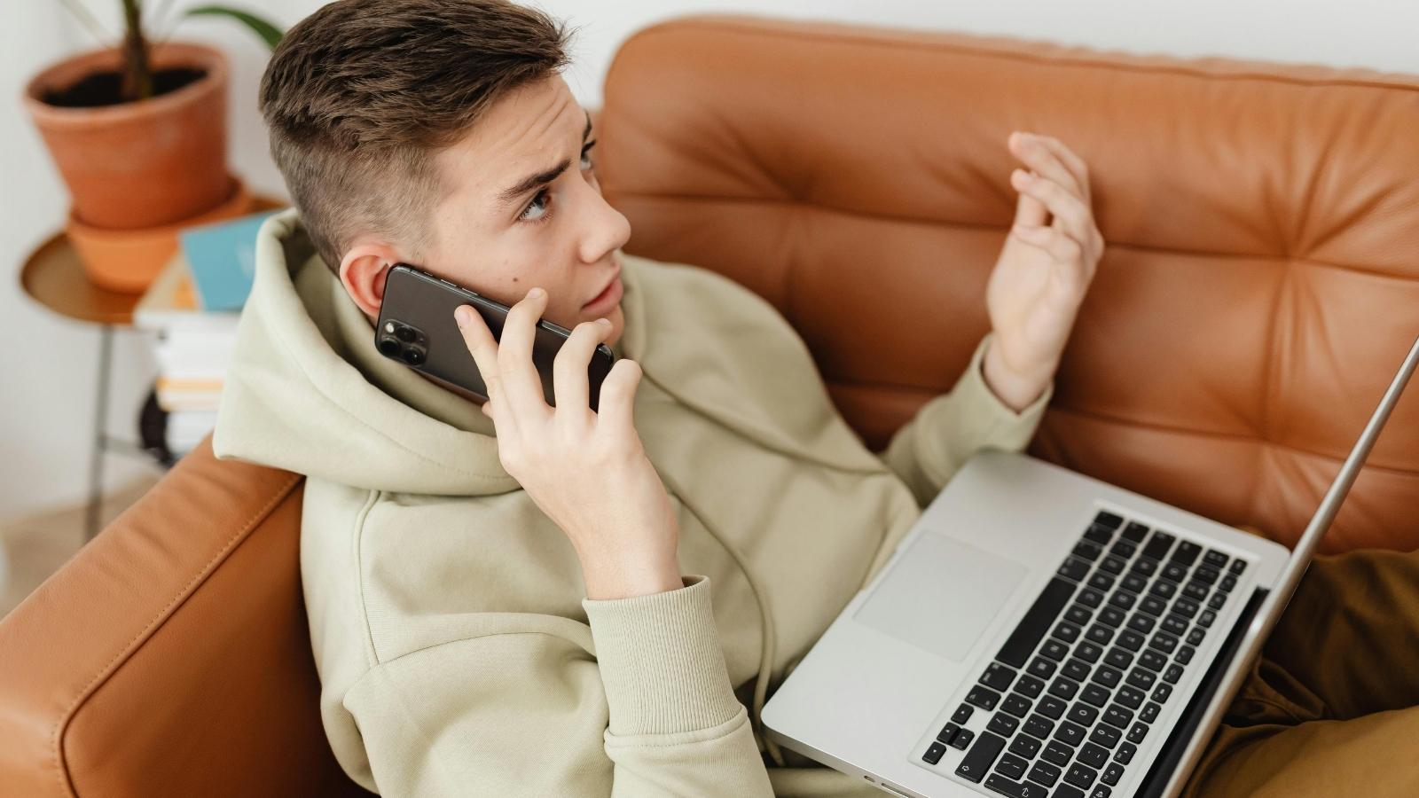 man lounging on his laptop on the couch