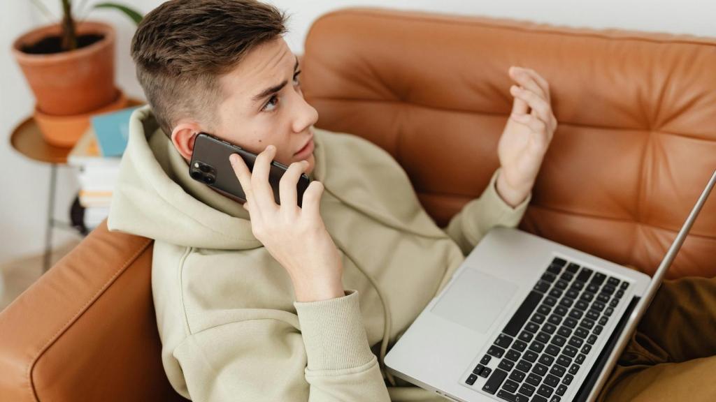 man lounging on his laptop on the couch