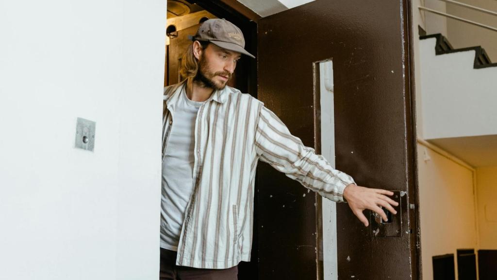 man opening his apartment door
