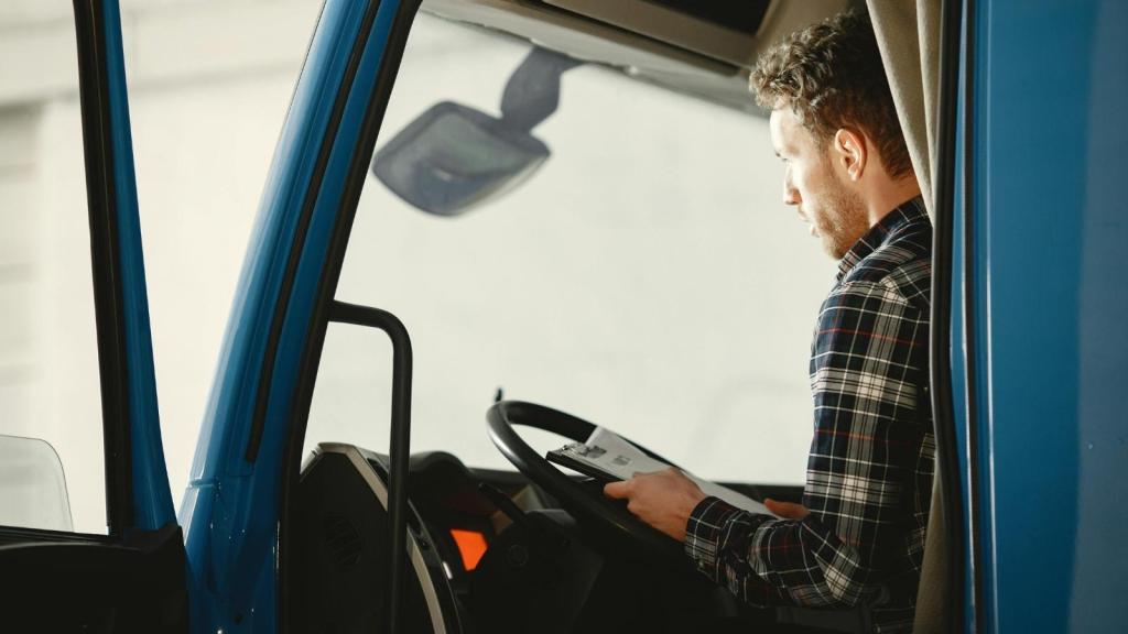 man sitting at the wheel of a big truck