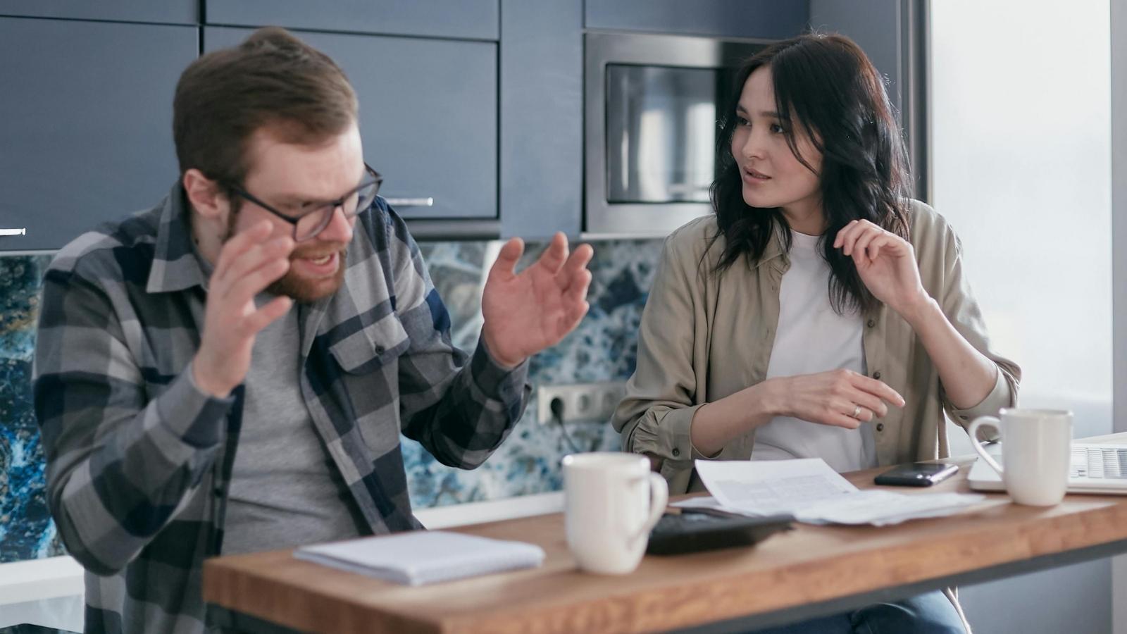 married couple arguing about bills