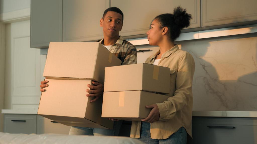 people holding moving boxes