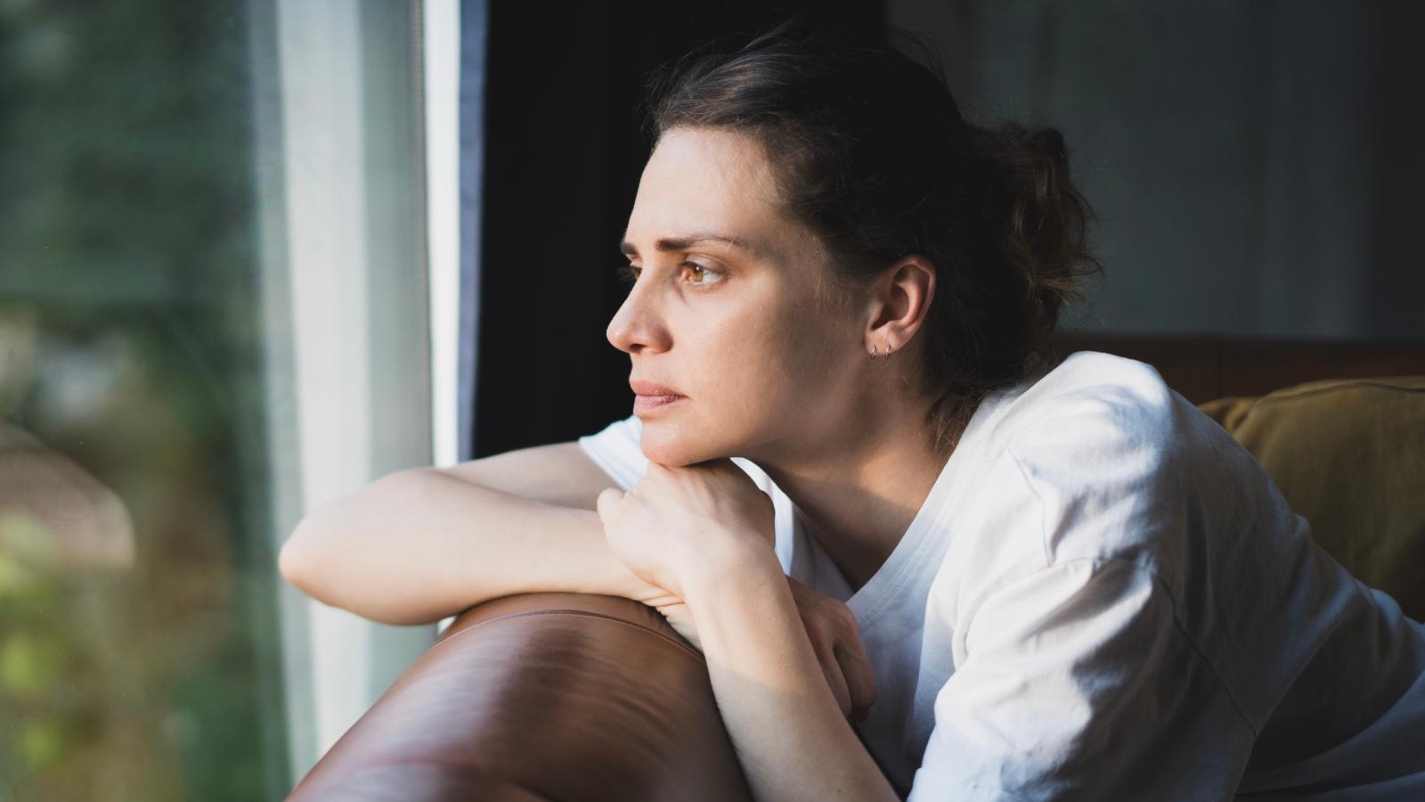 woman looking out a window