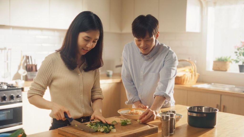 couple chopping broccoli