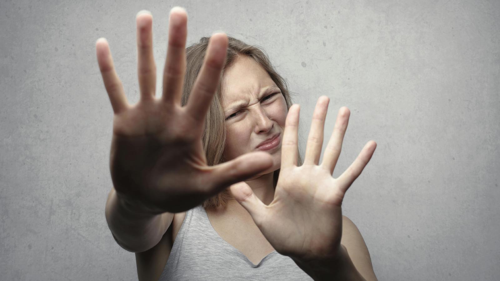 A Shared Home Became Challenging Because of One Roommate’s Intense Spider Phobia woman holding her hands up