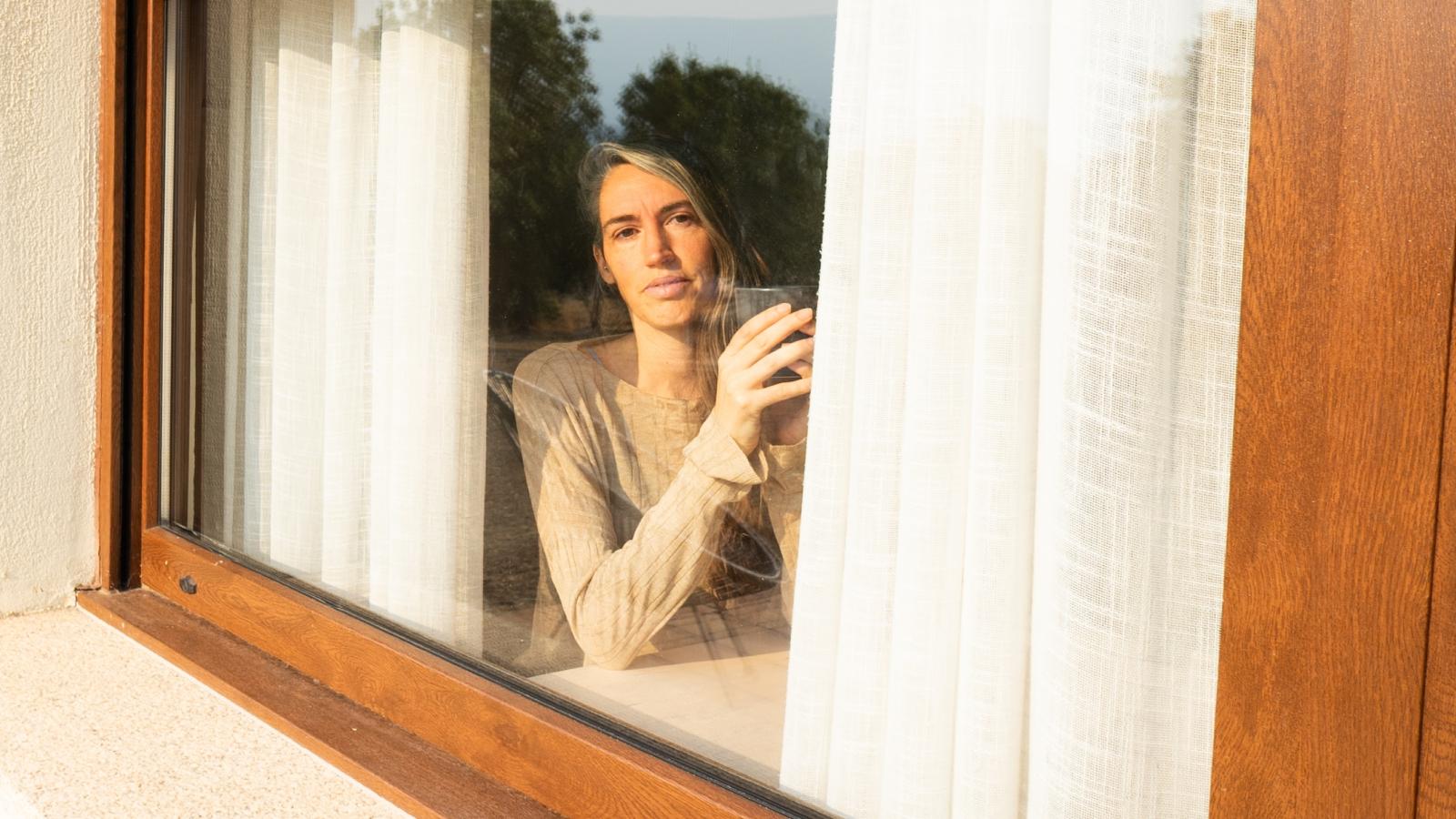 woman looking out window