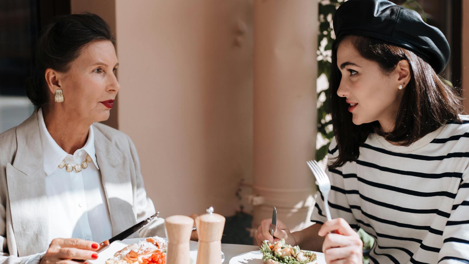 A Family Wedding Plan Took an Unexpected Turn After One Sister Was Left Off the Guest List two women eating dinner