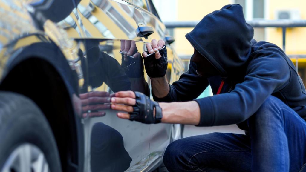 man vandalizing a car