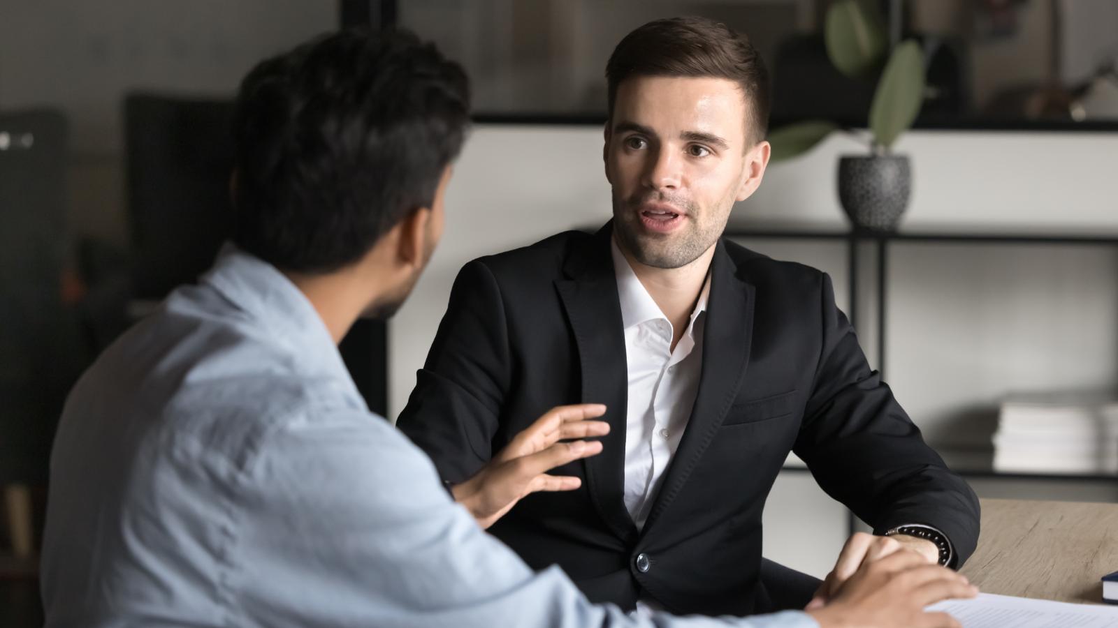 Employee Shocked After Coworkers Mock New Hire Over His Food Choices men in an office