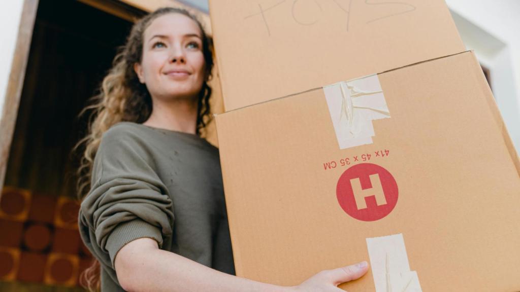woman carrying moving boxes