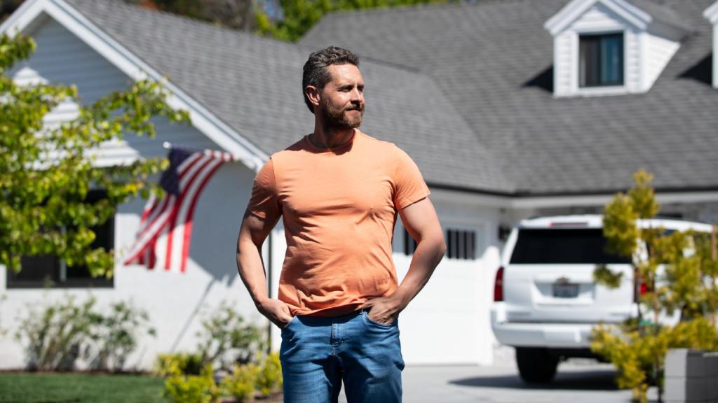 man in front of his house