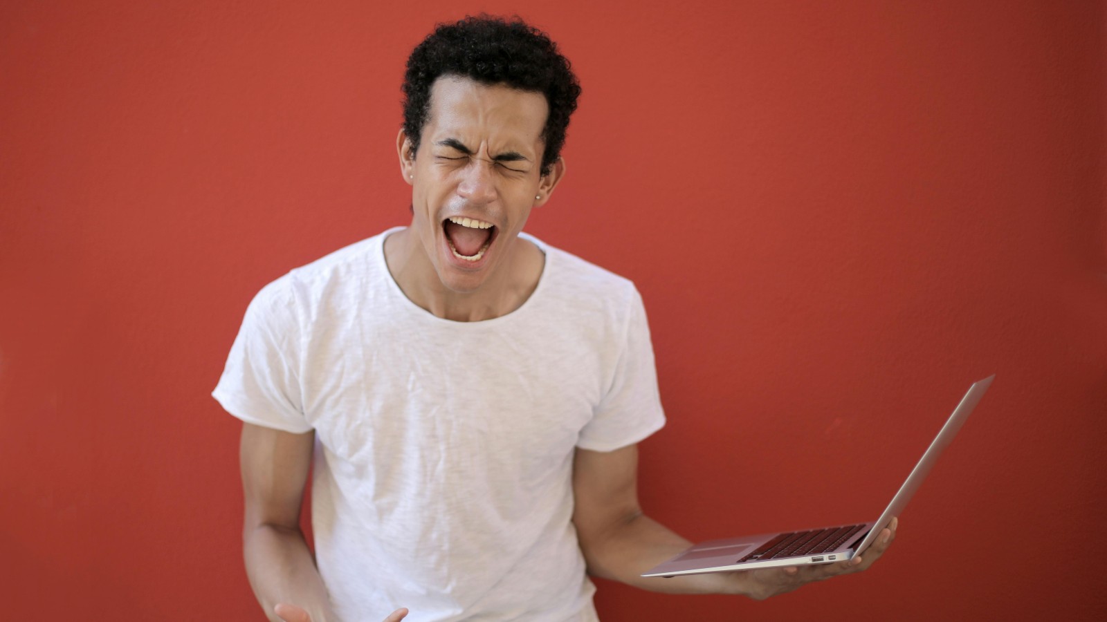 His Boss Tried To Have Him Take The Fall For A Company Wide Issue, But He Beat Them At Their Own Game A man holding a laptop and shouting.