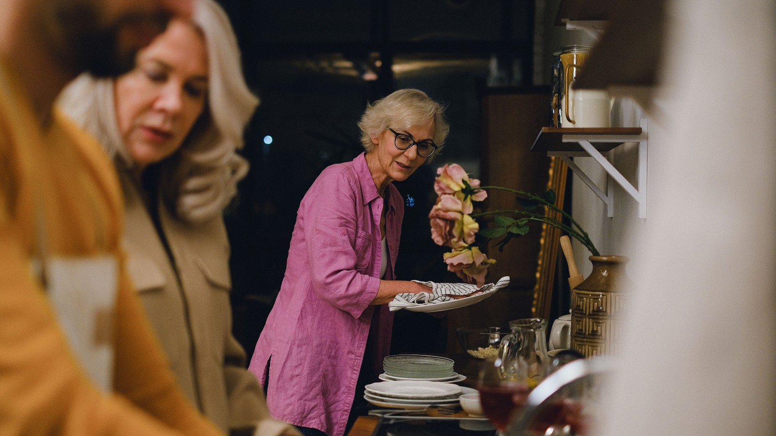 an older woman washing dishes