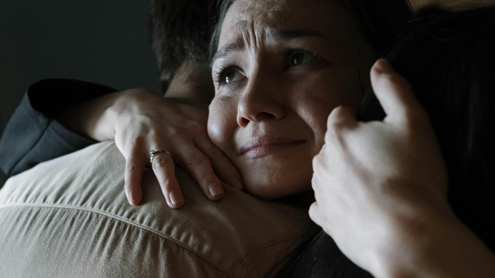 sad woman hugging a man