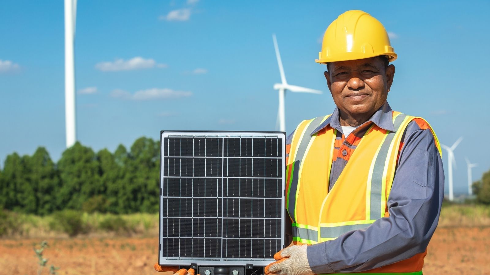 man holding up a solar panel