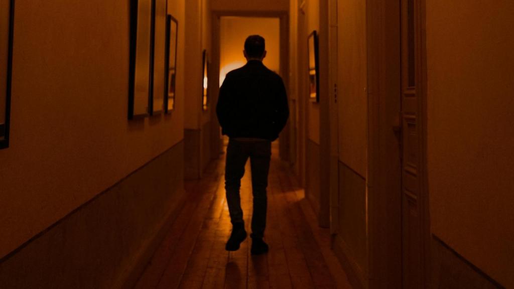 shadow of a man walking in a hallway