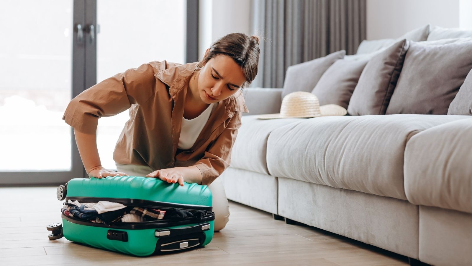 young woman packing a suitcase
