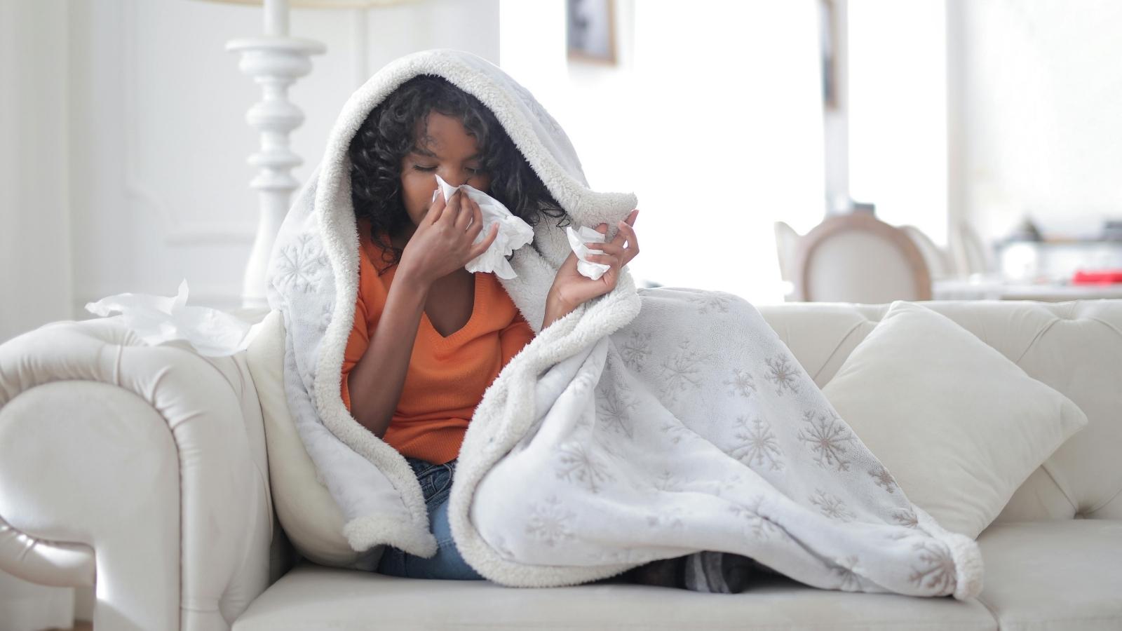 sick woman under a white blanket