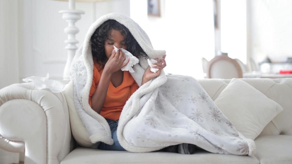 sick woman under a white blanket