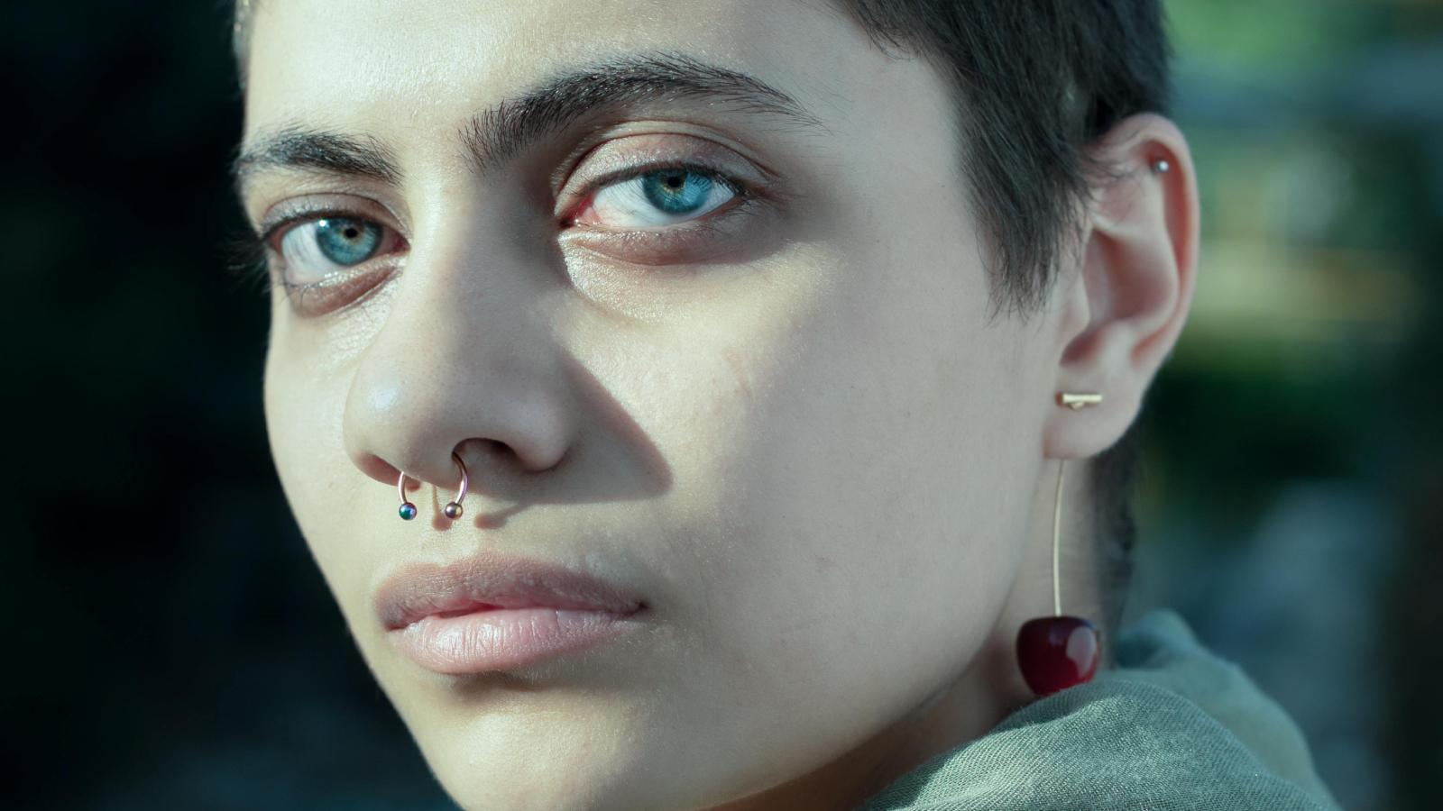 The Cool Sister Cost: How a Simple Trip to the Piercing Parlor Fractured the Trust Between a Mother and Her College Graduate woman with a septum piercing