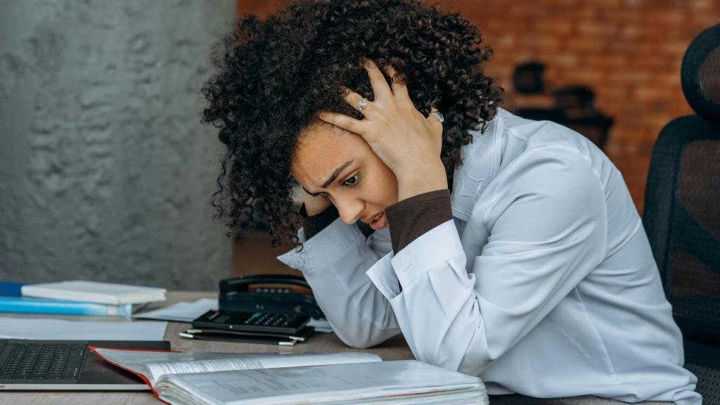 stressed professional woman sitting at her desk