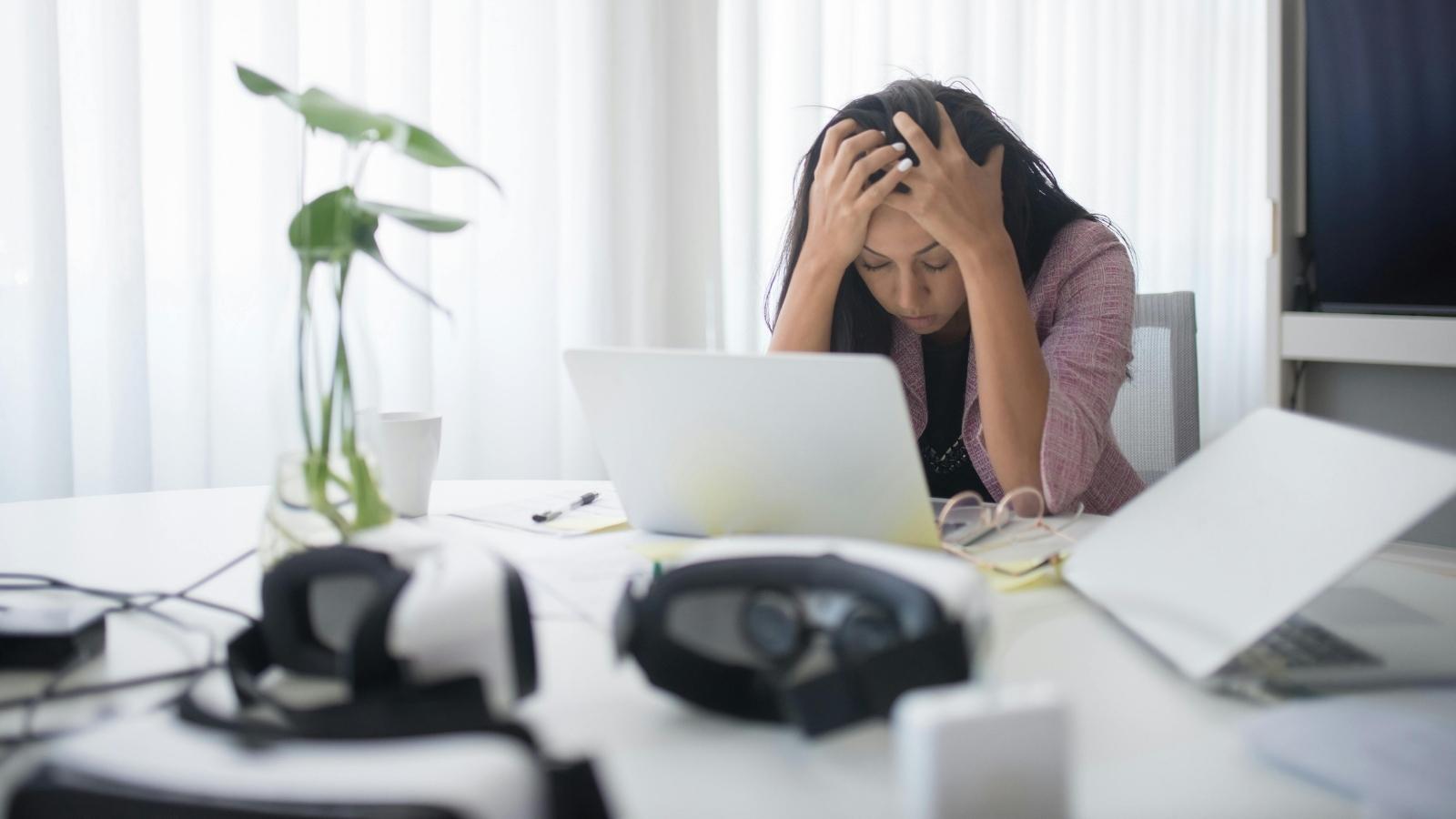 stressed woman sitting at her desk