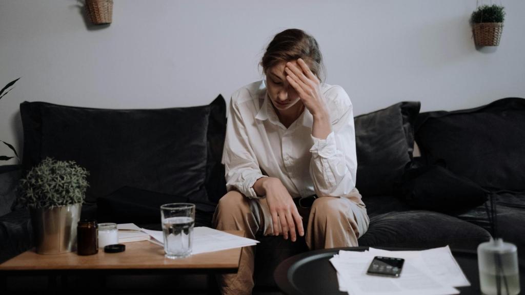 stressed woman sitting on the couch
