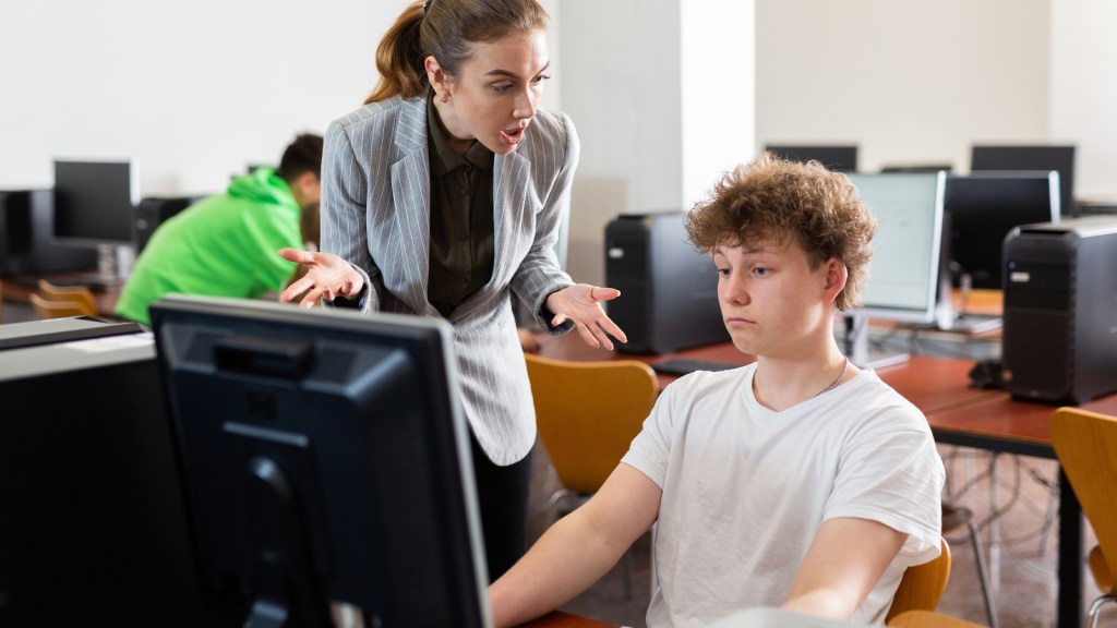 A teacher upset with a student in a computer lab