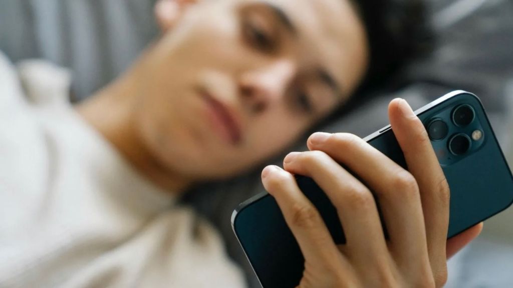 teen boy looking at phone