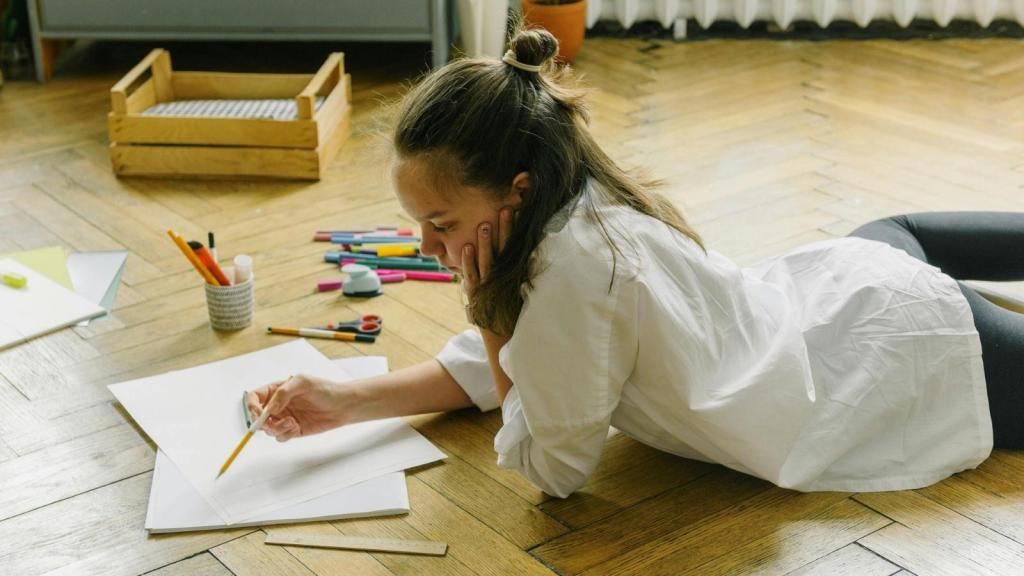 teenage girl drawing on the floor