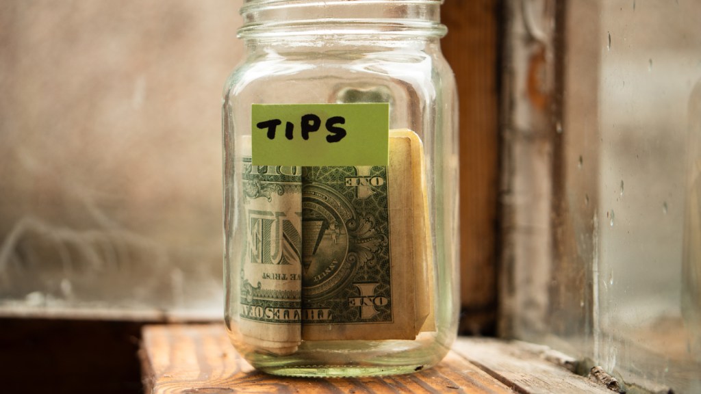 A tip jar with cash inside