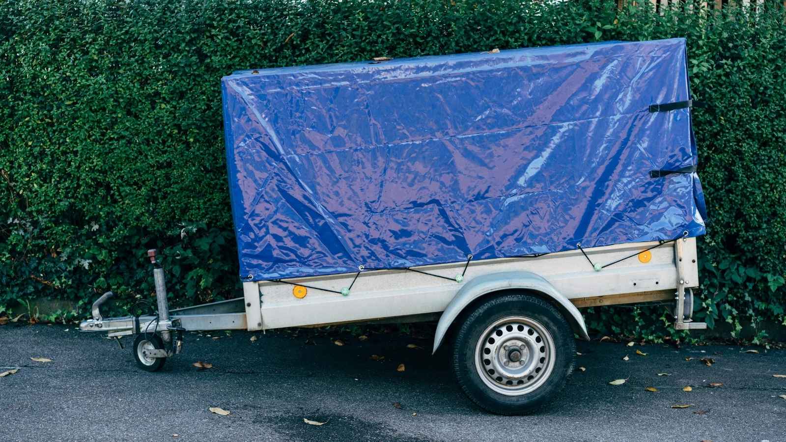 trailer covered in a blue tarp