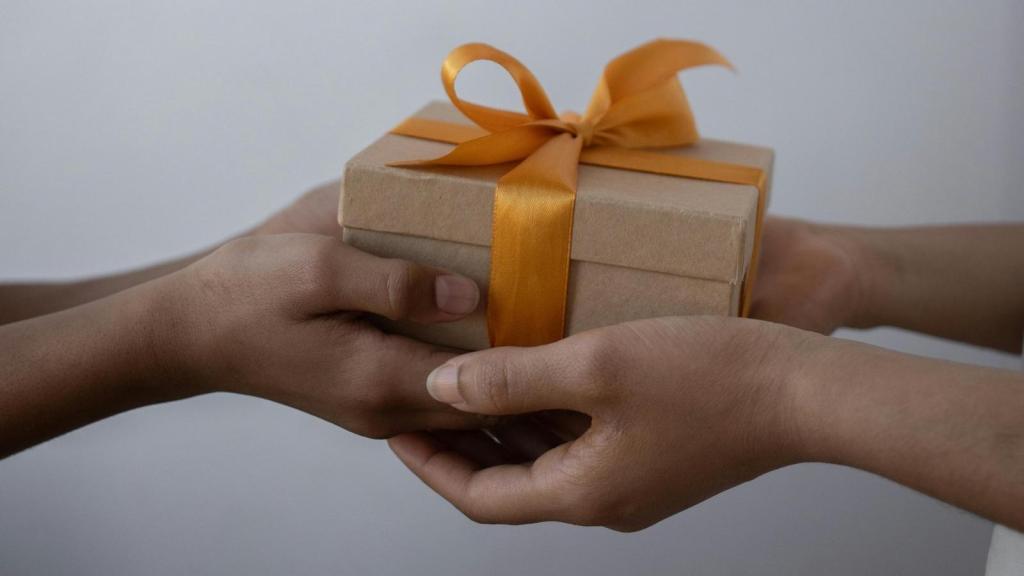 two people exchanging a gift