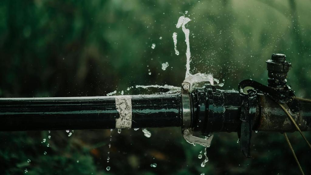 water leak gushing out of a pipe