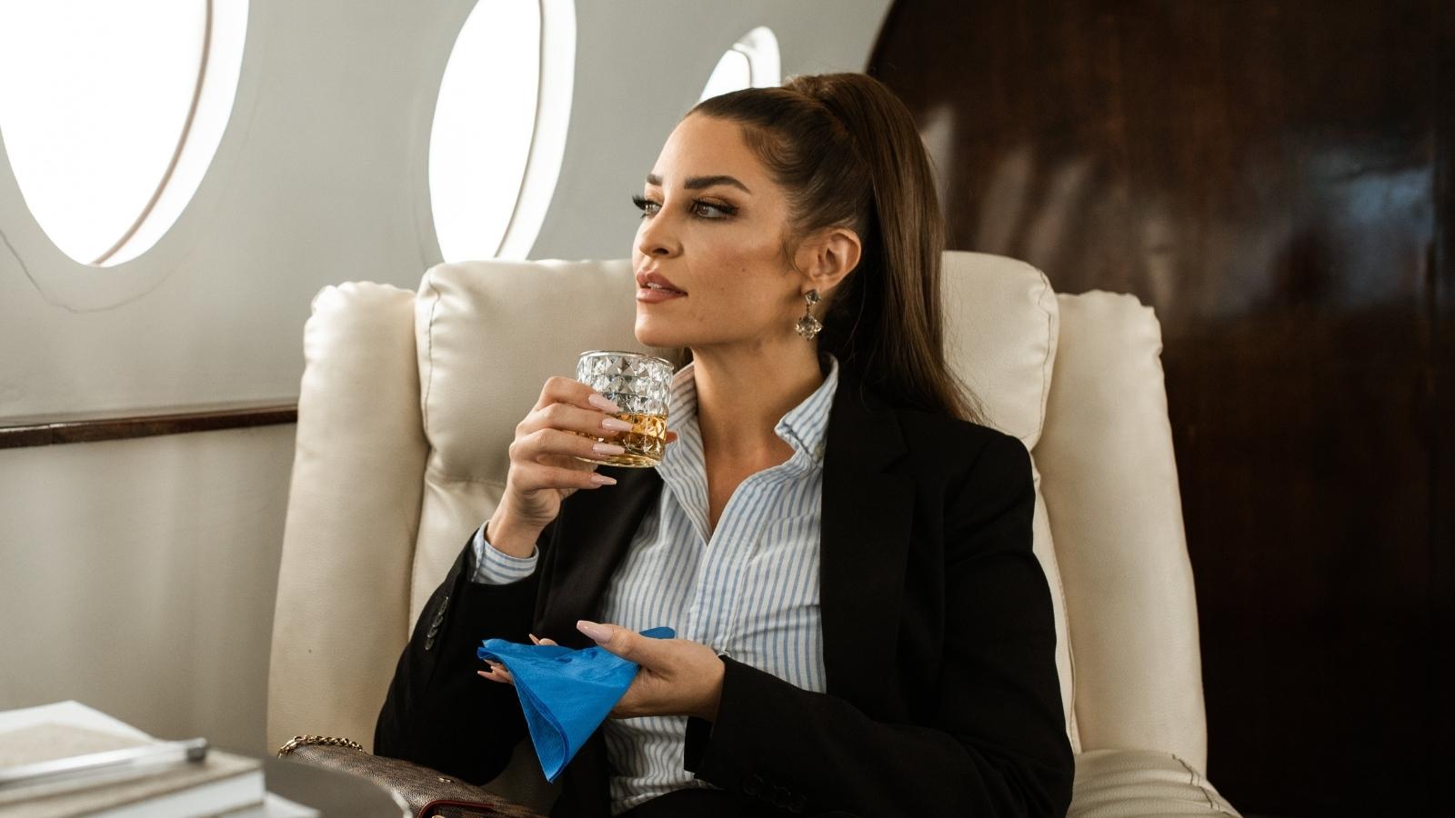 wealthy woman sitting on a plane