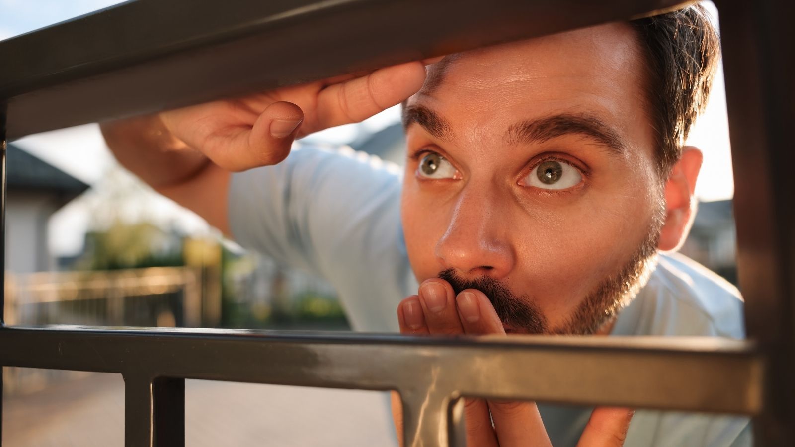 Woman Dealt With a Neighbor Staring at Her Home and Recording Her Husband in the Shower, so She Called the Police neighbor spying through the fence