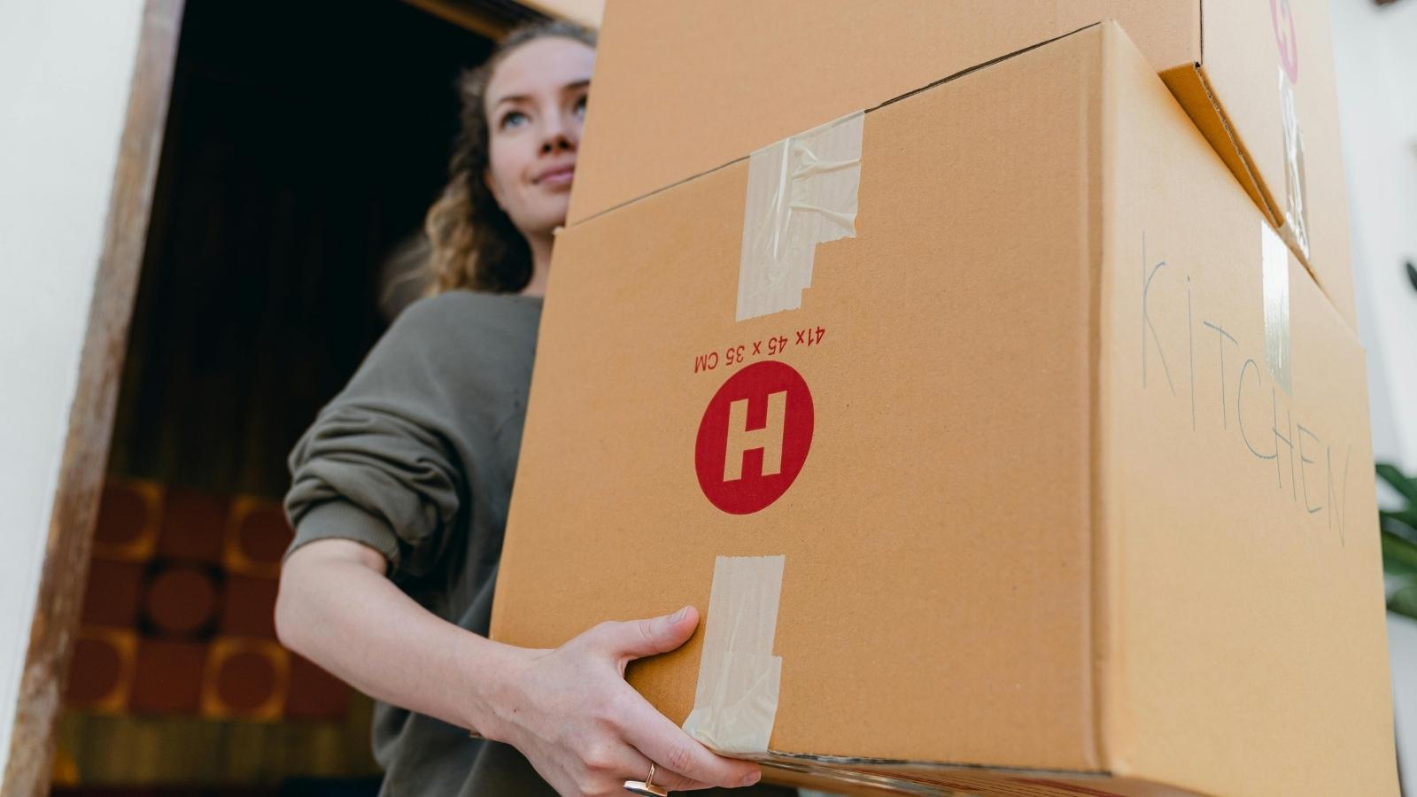 woman holding moving boxes