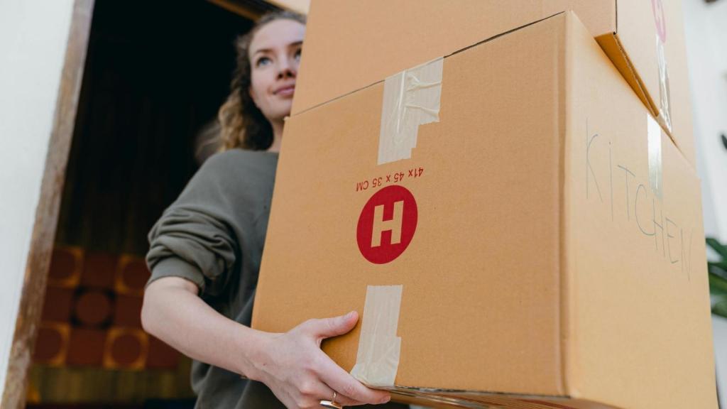 woman holding moving boxes