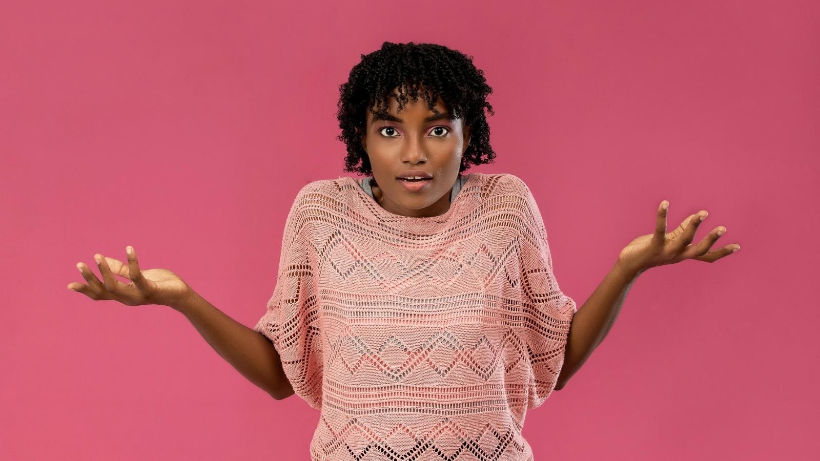 He Forgot to Request Time Off to Propose to His Girlfriend, and When a Coworker Refused to Cover His Shift, He Blamed Her woman in pink shirt shrugging