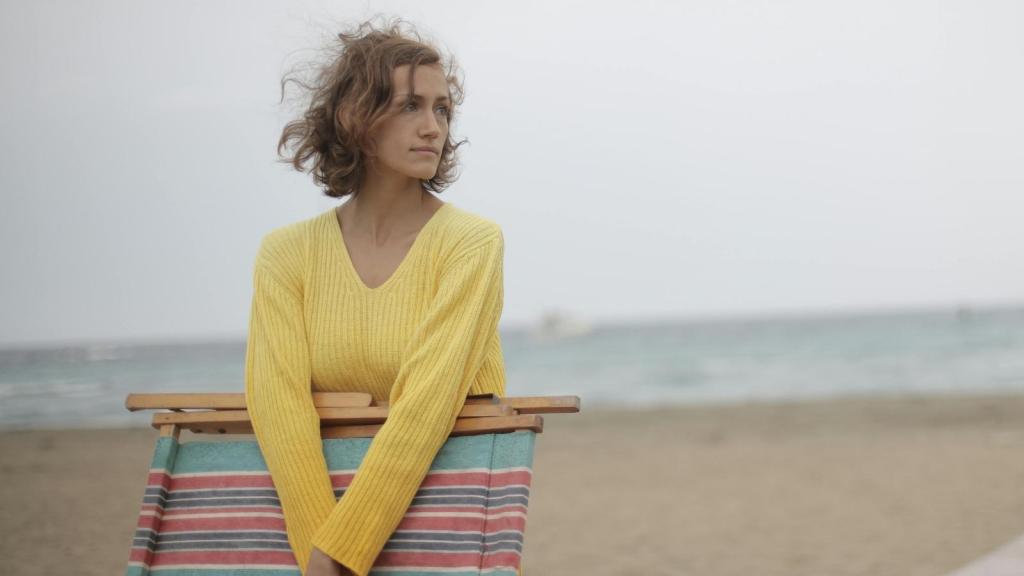 woman in yellow shirt on the beach