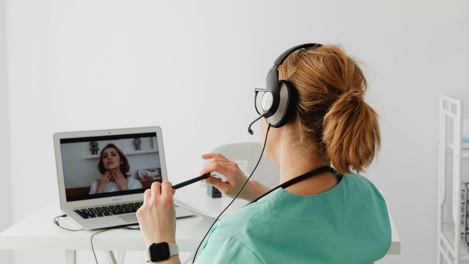 A Woman Noticed Strange Behavior From Her Neighbors Every Time She Started a Therapy Session woman sits on a telehealth call