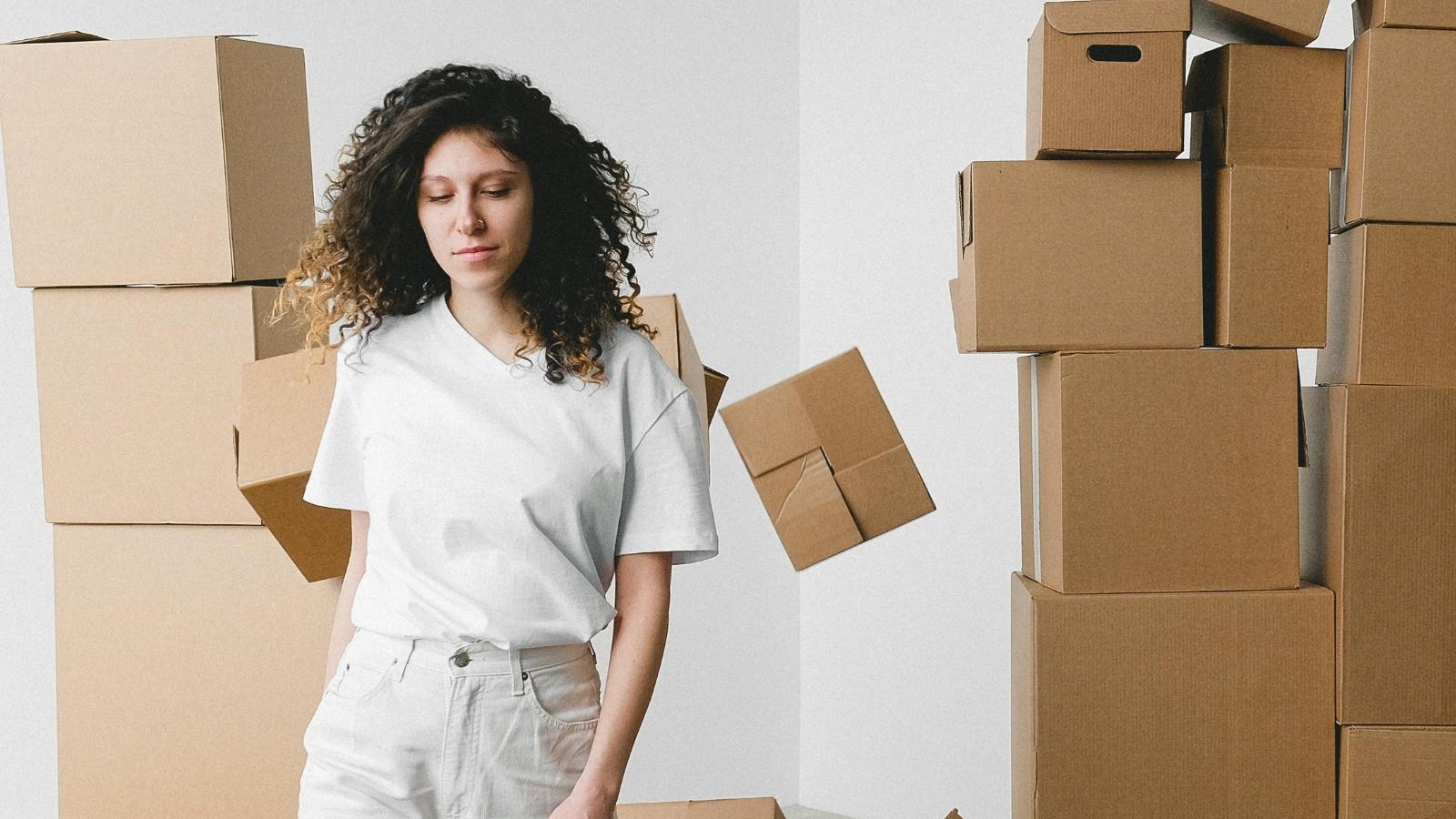 woman surrounded by moving boxes