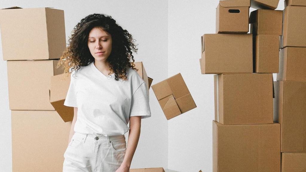 woman surrounded by moving boxes